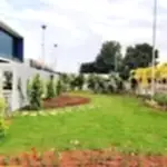Commercial & Contract Gardening Services Perth – Well-maintained corporate landscape with lush green lawn, trees, and decorative plants.