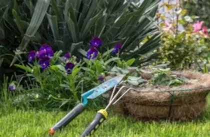 Commercial & Contract Gardening Services Perth – Professional garden maintenance tools and fresh green lawn with vibrant flowers.