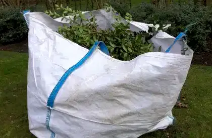 Green waste collection Perth – large garden waste bag filled with trimmed branches and leaves ready for eco-friendly disposal